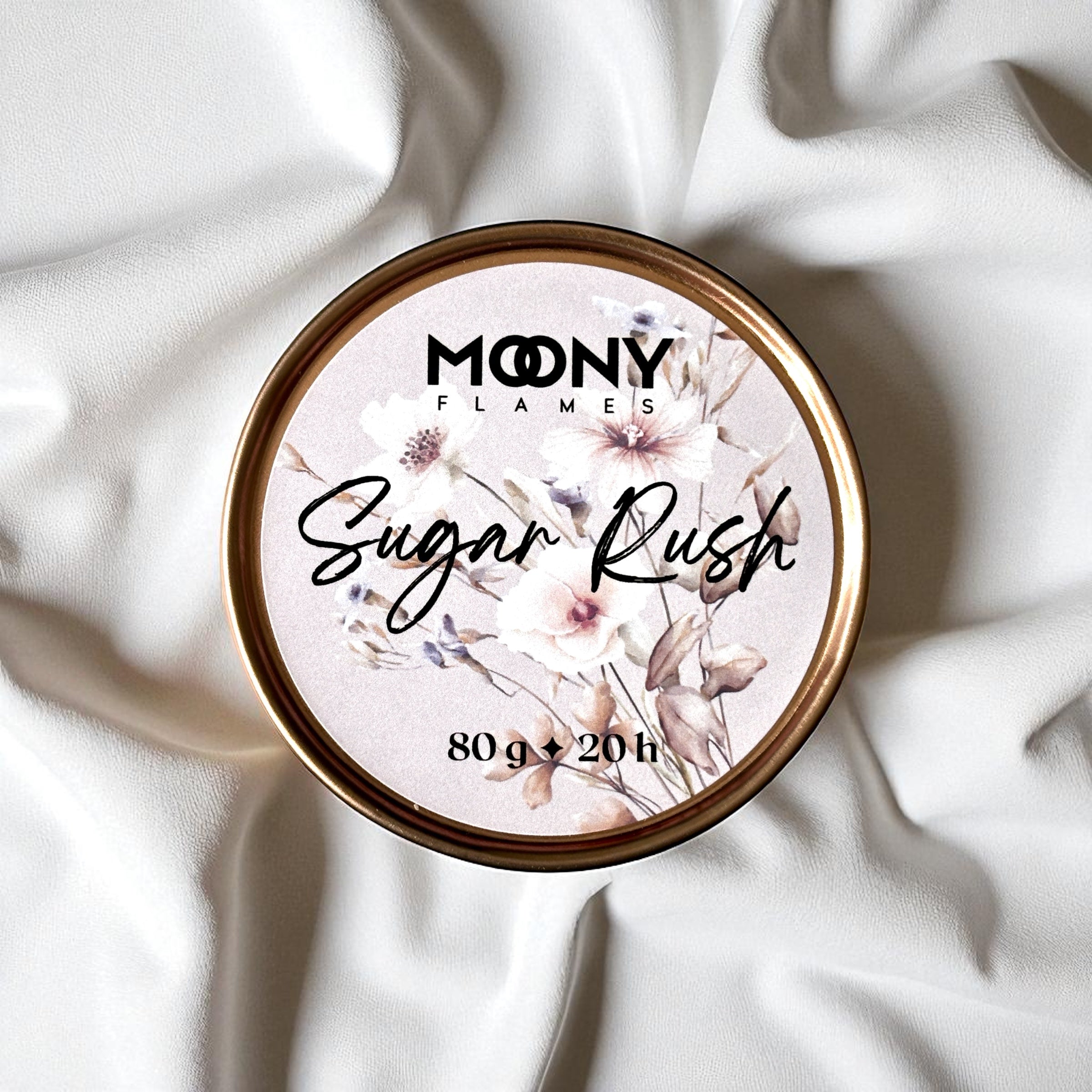 Doftljus Sugar Rush i roseguld metallburk uppifrån på en vit duk. Reseljus - Moony Flames