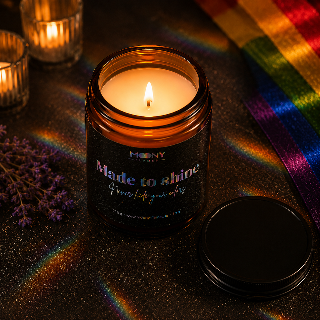 Made to Shine handmade Pride candle by Moony Flames with black lid, amber glass jar and holographic rainbow label. Vegan scented candle handcrafted in Sweden.