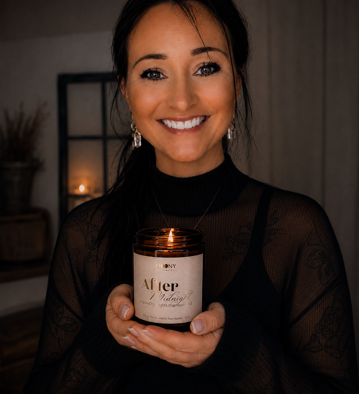 Founder of Moony Flames holding the handmade scented candle “After Midnight” in a warm and cozy indoor setting in Sweden.