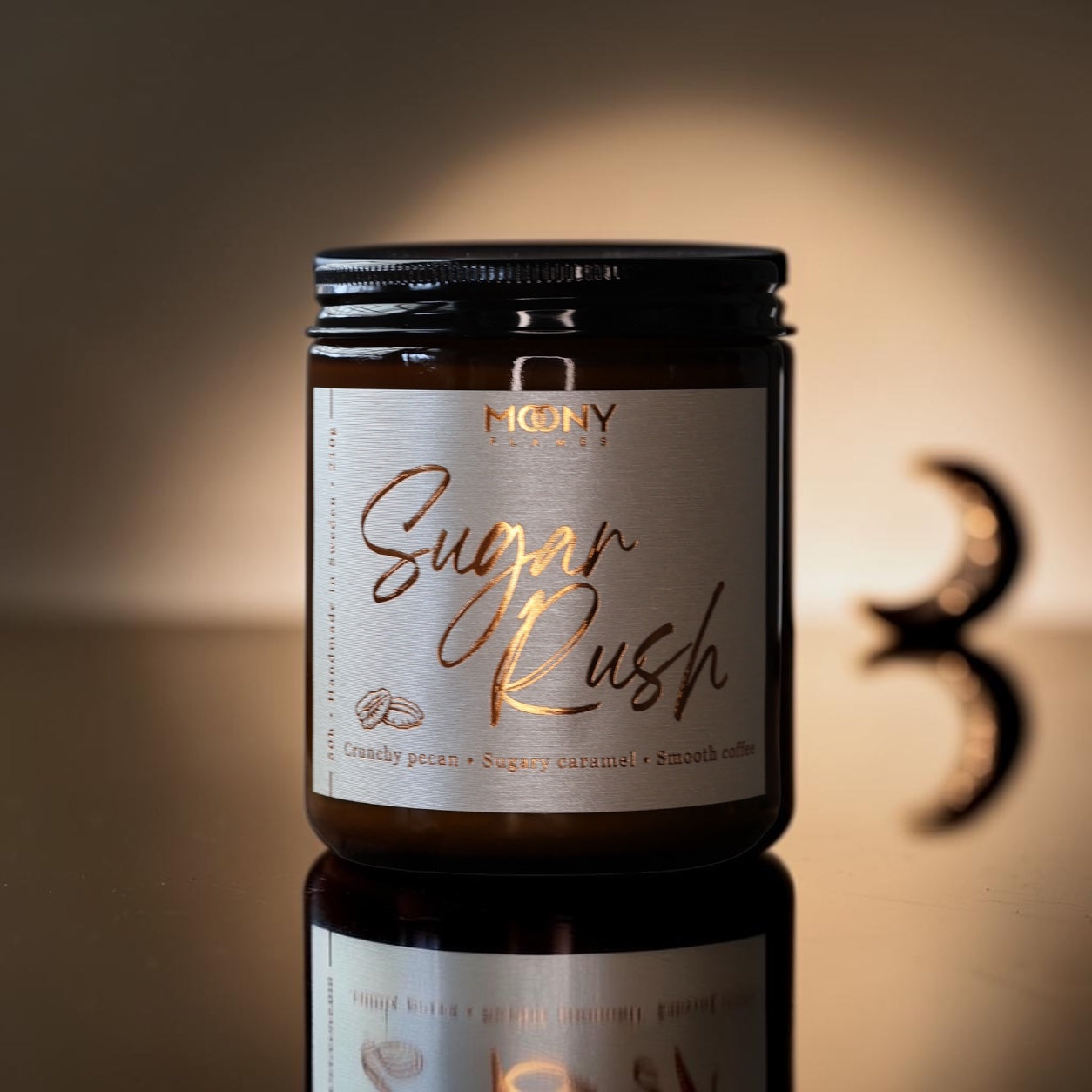 Sugar Rush är ett handgjort doftljus från Moony Flames, inspirerat av nybakade sötsaker, krispig pekannöt och len karamell som fyller hemmet med värme och känslan av en mysig fikastund.